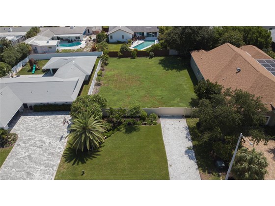 Separate driveway with gate to the additional lot. - Single Family Home for sale at 345 7th Ave N, Tierra Verde, FL 33715 - MLS Number is U8135988