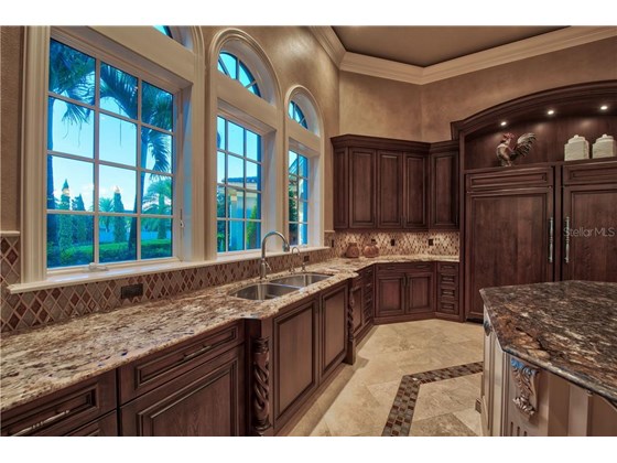 Tile Backsplash, Solid Wood Cabinetry, Stone Counters and Cleverly Hidden Appliances - Single Family Home for sale at 8499 Lindrick Ln, Bradenton, FL 34202 - MLS Number is A4475594