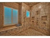 Walk-In Shower with Tile Detailing, Bench and Multiple Shower Heads - Single Family Home for sale at 8499 Lindrick Ln, Bradenton, FL 34202 - MLS Number is A4475594