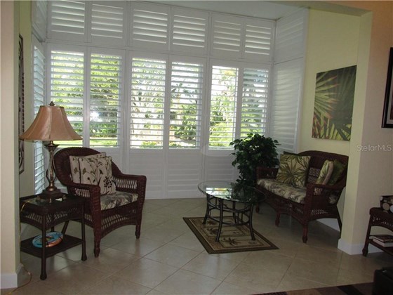 ENCLOSED LANAI WITH PLANTATION SHUTTERS VIEW OF THE LAGOON - Condo for sale at 1087 W Peppertree Dr #221d, Sarasota, FL 34242 - MLS Number is A4493593