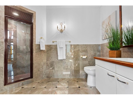 En suite bathroom with shower from Den Study area - Single Family Home for sale at 6211 Gulf Of Mexico Dr, Longboat Key, FL 34228 - MLS Number is A4511733