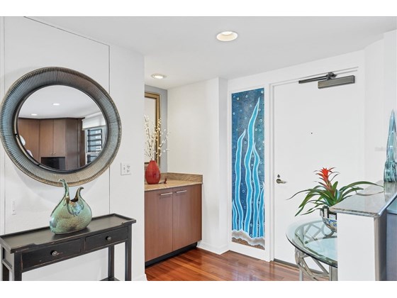 Enter your condo through the beautiful glass entry way.  Engineered wood floors throughout. - Condo for sale at 1255 N Gulfstream Ave #503, Sarasota, FL 34236 - MLS Number is A4519355