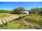 Wooden Bridge over Pond from House to Barn - Single Family Home for sale at 16411 Waterline Rd, Bradenton, FL 34212 - MLS Number is A4519463
