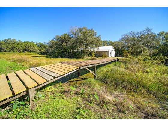 Wooden Bridge over Pond from House to Barn - Single Family Home for sale at 16411 Waterline Rd, Bradenton, FL 34212 - MLS Number is A4519463
