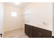 Laundry room offers plenty of space and sink - Single Family Home for sale at 13181 Steinhatchee Loop, Venice, FL 34293 - MLS Number is A4519994