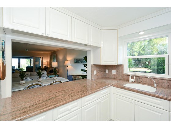 Kitchen with pass through to dining;  Also Bay Views across the living area! - Condo for sale at 450 Gulf Of Mexico Dr #B107, Longboat Key, FL 34228 - MLS Number is A4520786