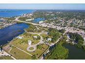 Ariel view, home is in center behind pool - Single Family Home for sale at 6751 Portside Ln, Englewood, FL 34223 - MLS Number is N6118322